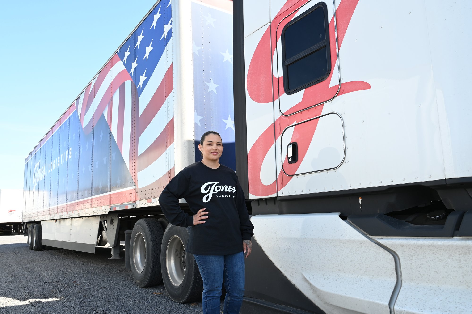 Amanda Ross, driver with Jones Logistics, is pictured in front of a patriotic truck.