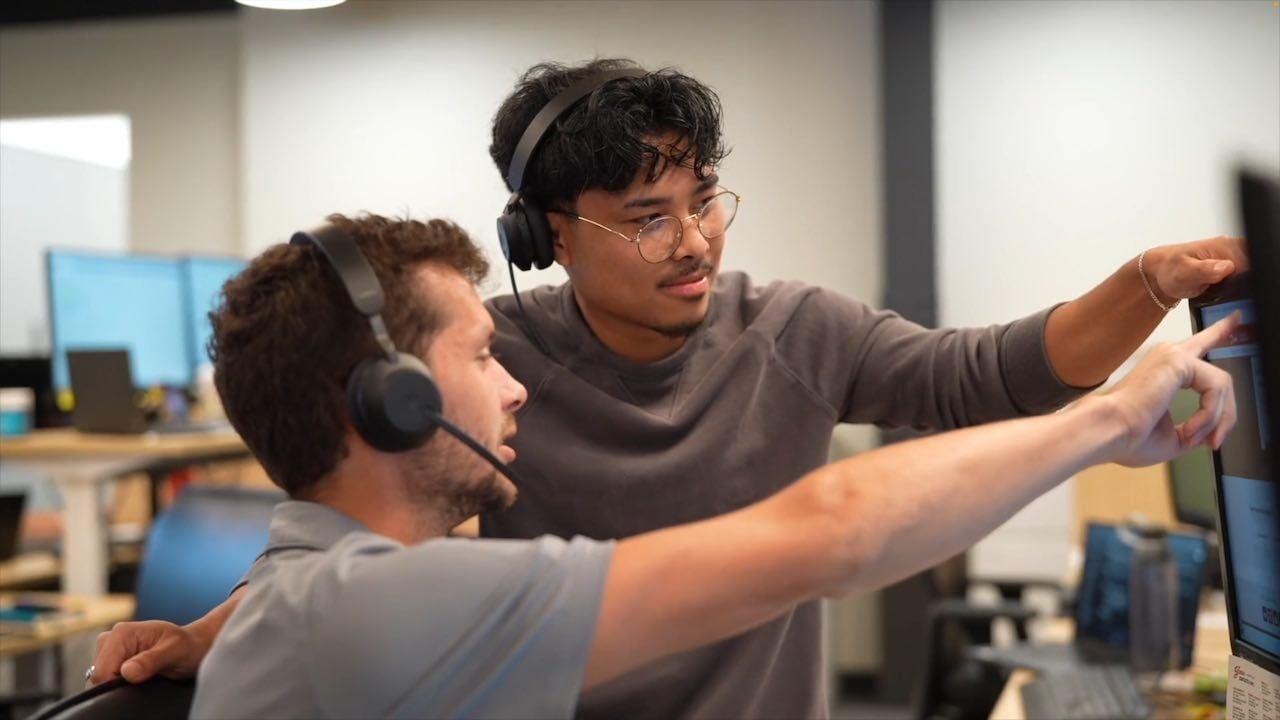 SM- Johntly & Zach Fielder looking at a computer