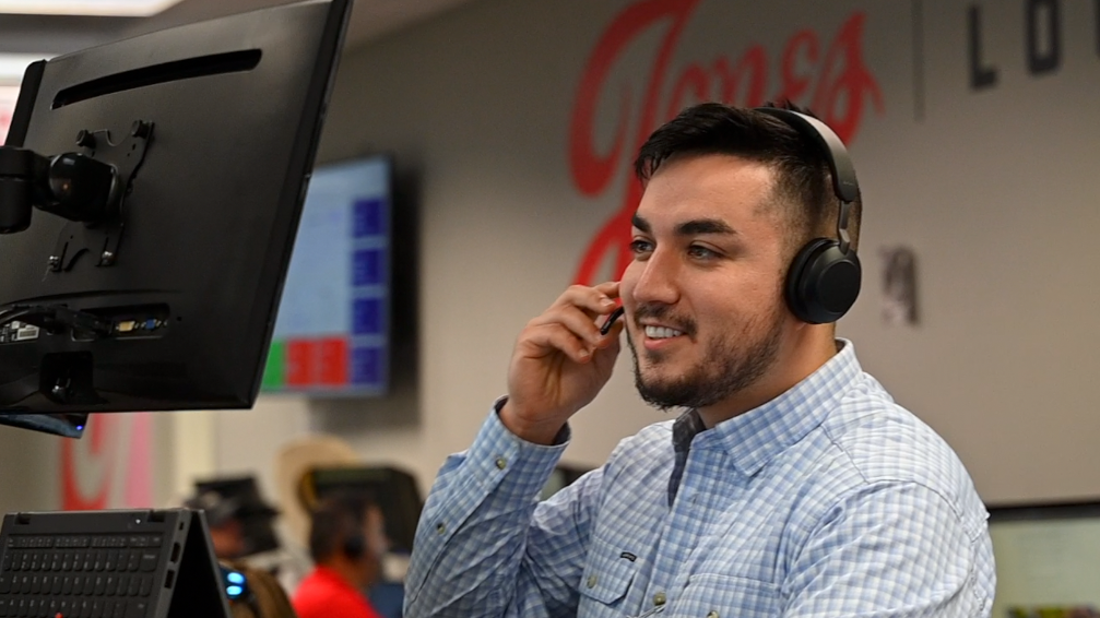 Jones employee looking at his computer smiling
